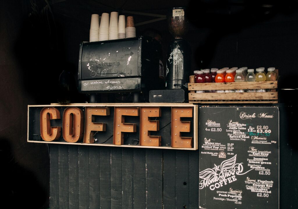 Coffee shop display with vintage decor, menu, and various bottled drinks.
